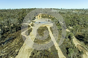 Drone aerial photograph of telephone lines running through a forest affected by bushfire in Australia