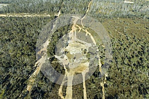 Drone aerial photograph of telephone lines running through a forest affected by bushfire in Australia