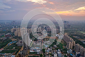 drone aerial shot showing busy traffic filled streets between skyscrapers filled with houses, homes and offices with a photo