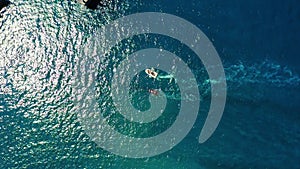 Drone aerial top down view of two boats float in the deep blue ocean. Tourist excursions. CLear sea water. Boat chasers