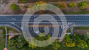Drone aerial top view new asphalt road in autumn on cloudy day, road markings