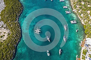 The drone aerial view of anchored sailing yacht in emerald Caribbean sea