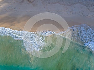 Drone aerial view at a beach in Phuket Thailand with huge waves, blue ocean waves from above