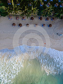 Drone aerial view at a beach in Phuket Thailand with huge waves, blue ocean waves from above