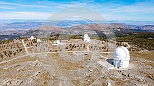 Drone aerial view of Calar Alto Observatory at the snowy mountain top in Almeria