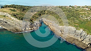 Drone aerial view of the cantabric sea coast. Cliff on the coast with turquoise sea on a sunny summer day
