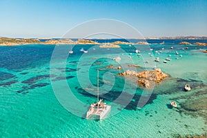 Drone aerial view of catamaran sailing boat in Maddalena Archipelago, Sardinia, Italy.