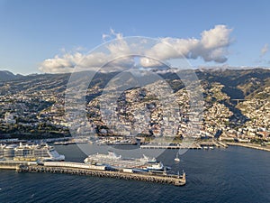 The drone aerial view of cruise ship mooring the port of Funchal