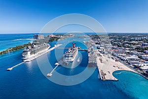 The drone aerial view of cruise ships in the clear blue Caribbean ocean docked in the port of Nassau, Bahamas