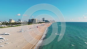 Drone aerial view at Miami South Beach Florida. Beach with colorful chairs and umbrellas