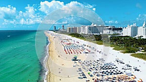 Drone aerial view at Miami South Beach Florida. Beach with colorful chairs and umbrellas