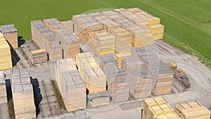 DRONE: Aerial view of neatly organized stacks of pine wood lying in a lumberyard