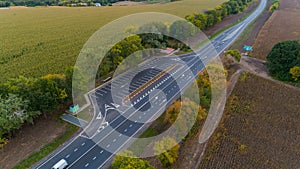 Drone aerial view new asphalt road in autumn on cloudy day, road markings