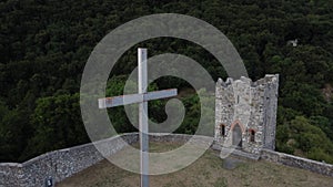 Drone aerial view of an old ruined medieval castle and the beautiful panorama of Lake Como at sunset