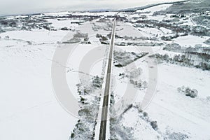 Drone aerial view of a road in a snowy landscape