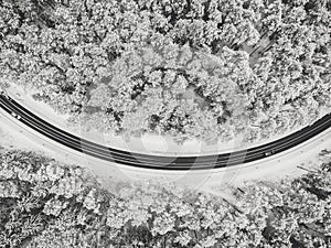 Drone aerial view of road in the snowy forest