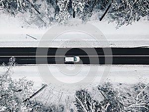 Drone aerial view of road in the snowy forest