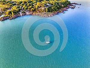 drone aerial view of a sailboat on a picturesque dam