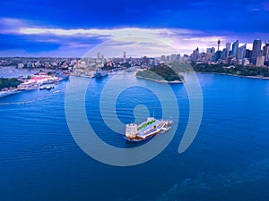 Drone Aerial view of Sydney Harbour Sydney CBD NSW Australia. cloudy dark skies, clear turquoise waters.