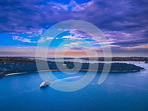 Drone Aerial view of Sydney Harbour Sydney CBD NSW Australia. cloudy dark skies, clear turquoise waters.