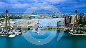 Drone Aerial view of Sydney Harbour Sydney CBD NSW Australia. cloudy dark skies, clear turquoise waters.