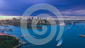 Drone Aerial view of Sydney Harbour Sydney CBD NSW Australia. cloudy dark skies, clear turquoise waters.