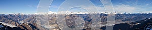 Drone aerial view to the Orobie Alps in a clear and blue day. Fresh snow on the mountains. Panorama from Farno mountain