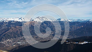 Drone aerial view to the Orobie Alps in a clear and blue day. Fresh snow on the mountains. Panorama from Farno mountain