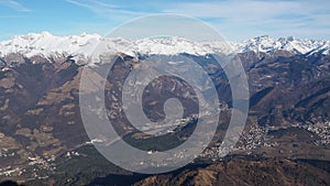 Drone aerial view to the Orobie Alps in a clear and blue day. Fresh snow on the mountains. Panorama from Farno mountain