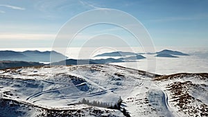 Drone aerial view to the Po plain and Farno Mountain. The fog covers all the villages and the Padana plain