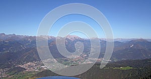 Drone aerial view to the Seriana valley and Orobie Alps in a clear and blue day