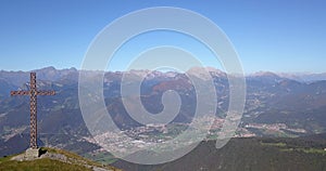 Drone aerial view to the Seriana valley and Orobie Alps in a clear and blue day. The cross at the top of the mountain