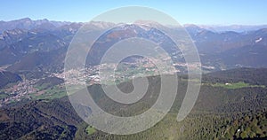 Drone aerial view to the Seriana valley and Orobie Alps in a clear and blue day. View of the highest mountains
