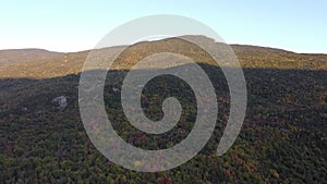 Drone aerial view of trees on Mount Washington and surrounding mountain range in Fall