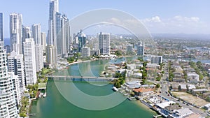 Drone, architecture and buildings with a bridge over water in Surfers Paradise, Queensland, Australia. Sky, highway and