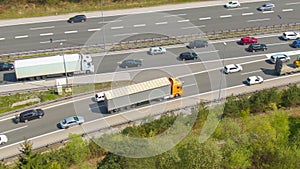 DRONE: Big orange 18 wheeler follows the congested traffic along the entry lane.
