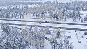 DRONE: Big Target truck hauls a heavy container along dangerous icy highway.