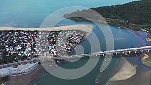 Drone, buildings and bridge in sea town, traffic and road with highway, ocean and transportation infrastructure. Horizon