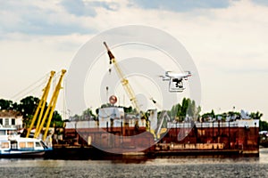 Drone with camera flying on container cargo ship at shipping port. double exposure