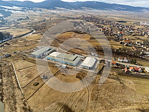 Drone camera flying over a small factory near Olt river.