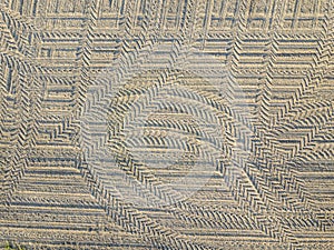 Tire marks in sand seen from above