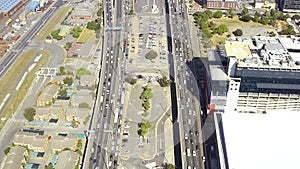 Drone, cars and commute on motorway with traffic for transportation, auto or metro for work. Cape Town, aerial view or