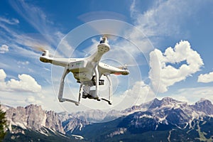 Drone copter flying with camera in mountains