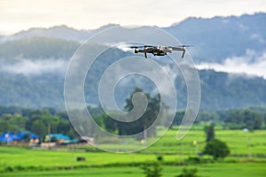 Drone copter flying with digital camera in mountains