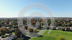 Drone crane shot video over a soccer field of the Riviere-Nord public park in St-Eustache at the beginning of Autumn