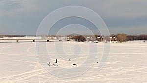 Drone crane view showing the frozen river between St-Eustache and Laval-Ouest and the bridge linking the two sides, with people