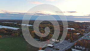 Drone crane view, at sunset, revealing the UFO golf in Fabreville at Fall with colorful trees