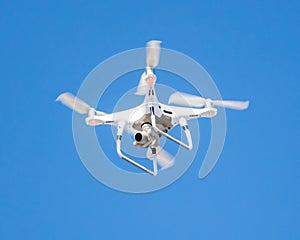 Drone with digital camera flying in the blue sky, closeup of photo