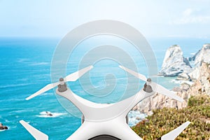 Drone with digital camera flying over the sea