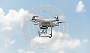 Drone with digital camera flying in the sky.